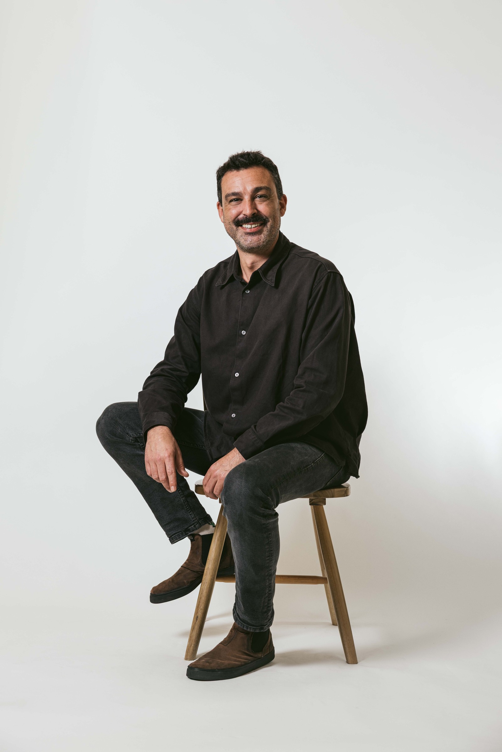 Richard Coelho seated for a studio portrait